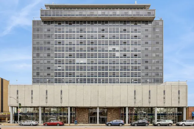 a living room with furniture a flat screen tv and a large window