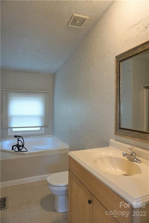 1291 Hines Road Clover, SC 29710 - Photo 14 of 26 a bathroom with a sink a toilet and mirror