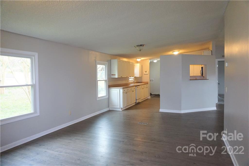 1291 Hines Road Clover, SC 29710 - Photo 19 of 26 a view of a kitchen with a fridge and wooden floor