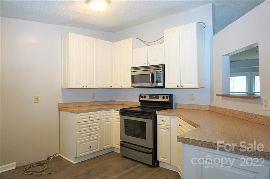 1291 Hines Road Clover, SC 29710 - Photo 4 of 26 a kitchen with stainless steel appliances white cabinets and a sink