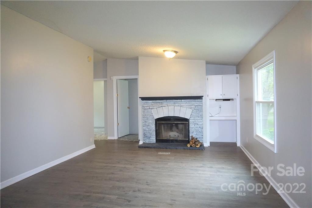 1291 Hines Road Clover, SC 29710 - Photo 6 of 26 a view of an empty room with a fireplace and a window