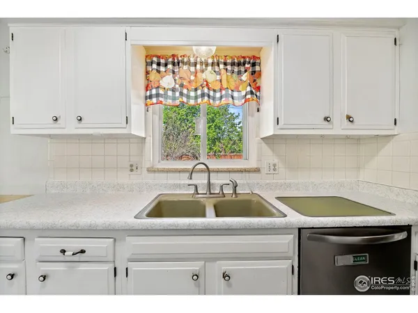 a kitchen with a sink and white cabinets