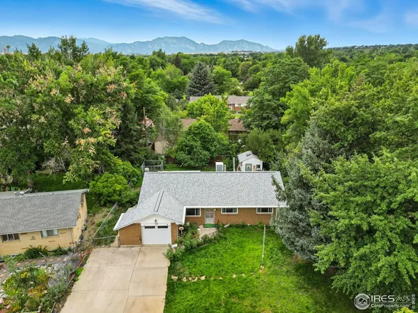 an aerial view of a house with yard and outdoor seating