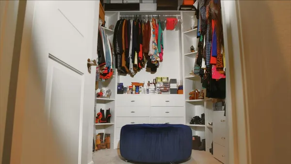 a view of walk in closet with clothes and shoes