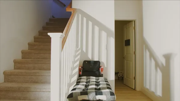 a view of hallway with stairs and furniture