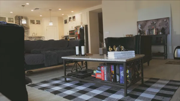 a dining room with furniture and a rug