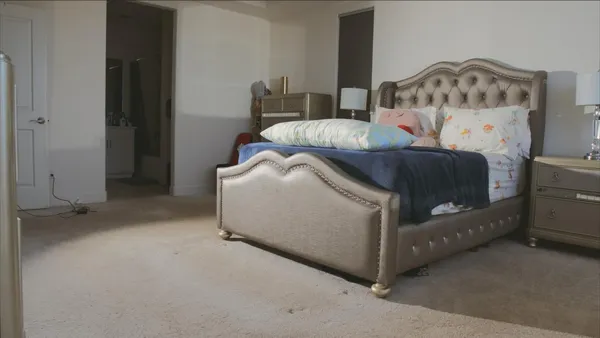 a bedroom with a bed and a couch