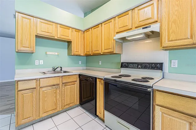 a kitchen with granite countertop cabinets stainless steel appliances and a sink