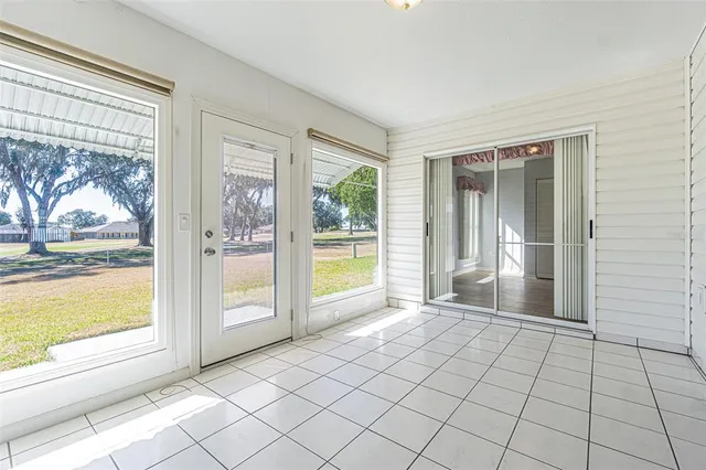 a view of an entryway with wooden floor and door