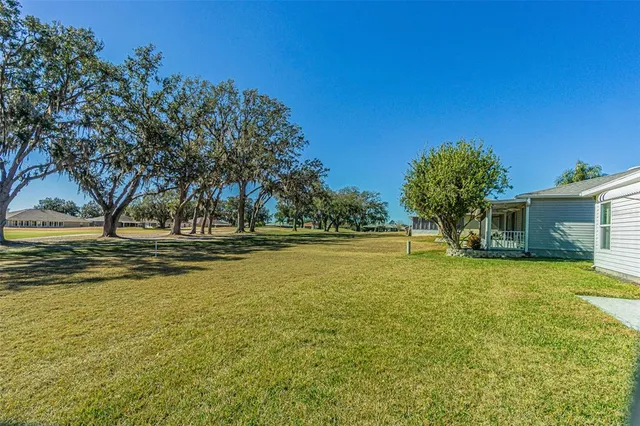 a view of swimming pool with outdoor seating and yard