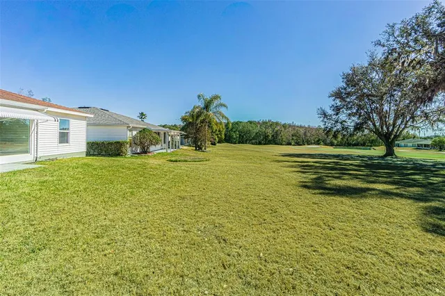 a view of a field with an trees in the background