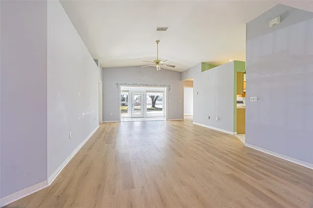 a view of a big room with wooden floor windows and cabinet
