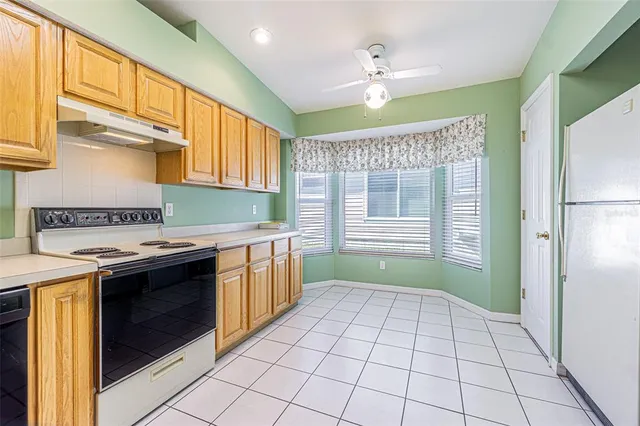 a kitchen with a stove a sink and a refrigerator