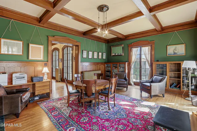 a kitchen with stainless steel appliances granite countertop a refrigerator a sink dishwasher a stove and white countertops with wooden floor