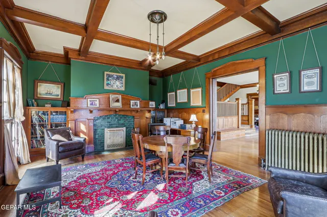 a kitchen with stainless steel appliances granite countertop a refrigerator a sink dishwasher a stove and white countertops with wooden floor