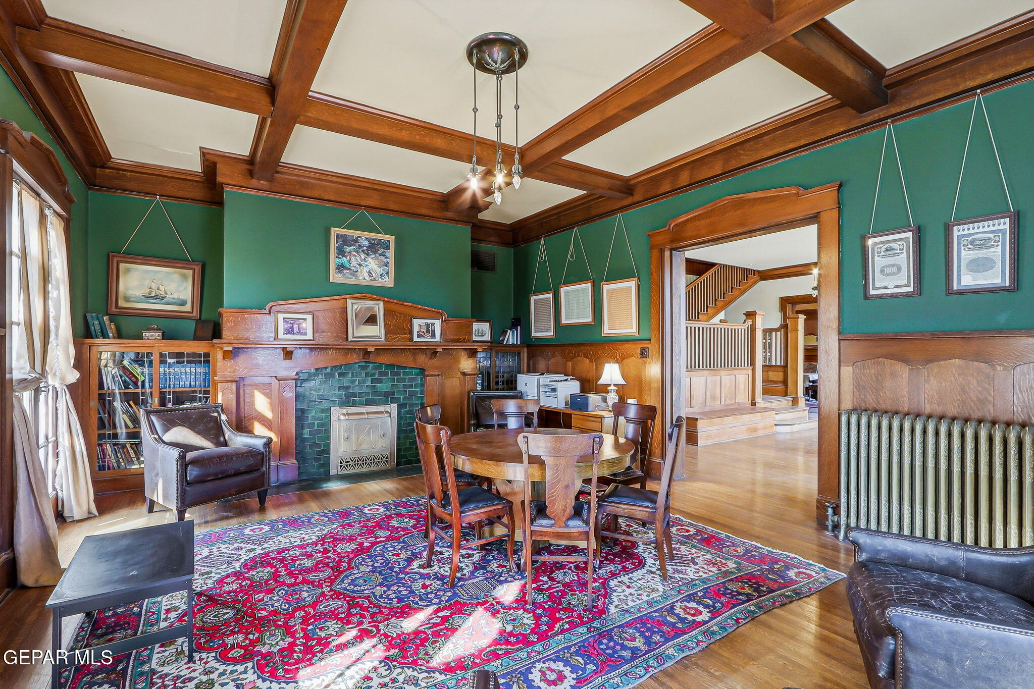 525 Corto Way El Paso, TX 79902 - Photo 12 of 98 a dining room with furniture wooden floor a rug and a chandelier