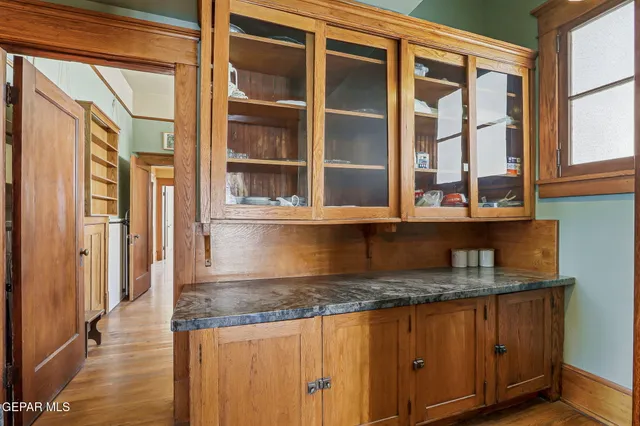 a view of a hallway with wooden floor and windows
