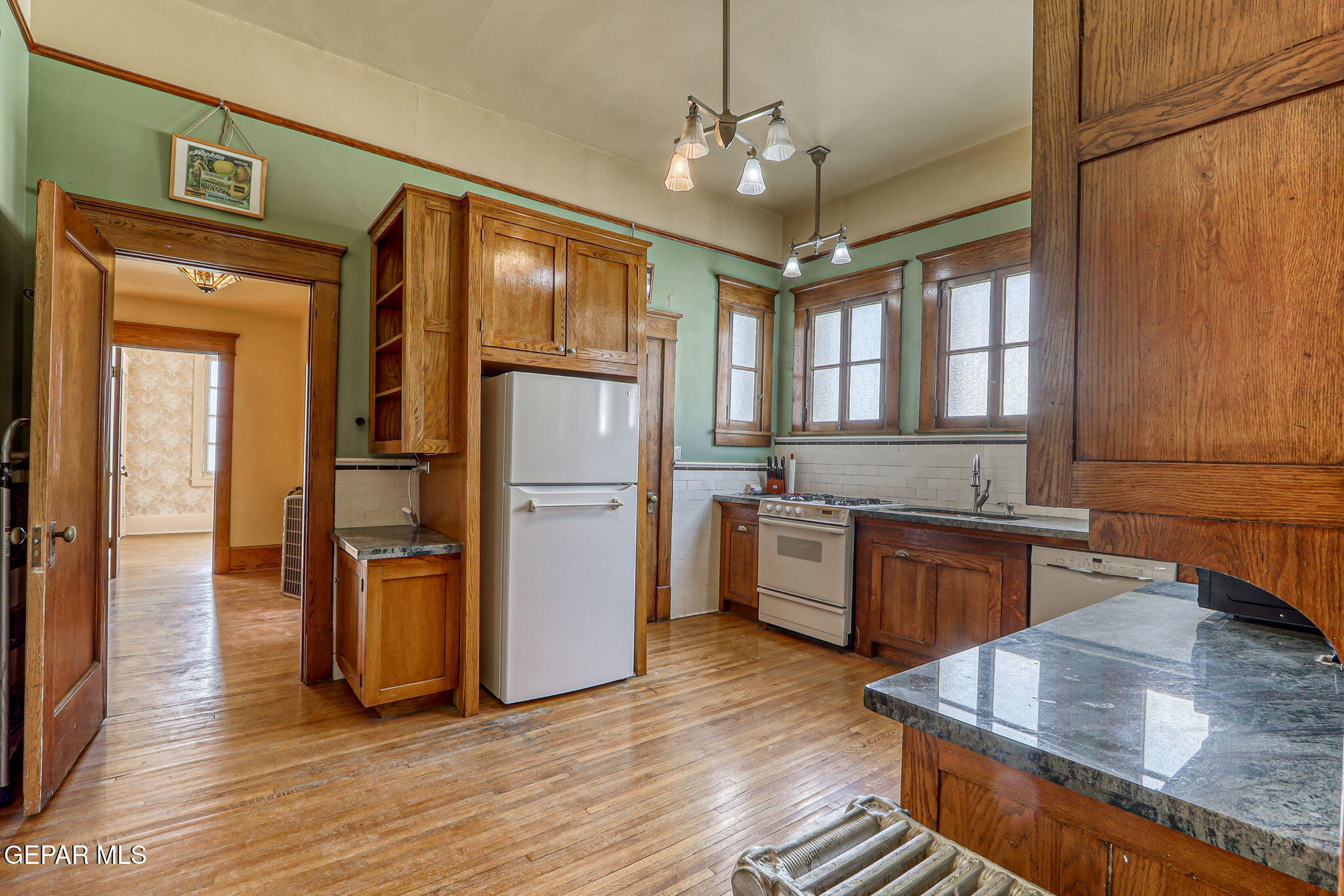 525 Corto Way El Paso, TX 79902 - Photo 22 of 98 a kitchen with stainless steel appliances granite countertop a refrigerator a sink dishwasher a stove and white countertops with wooden floor