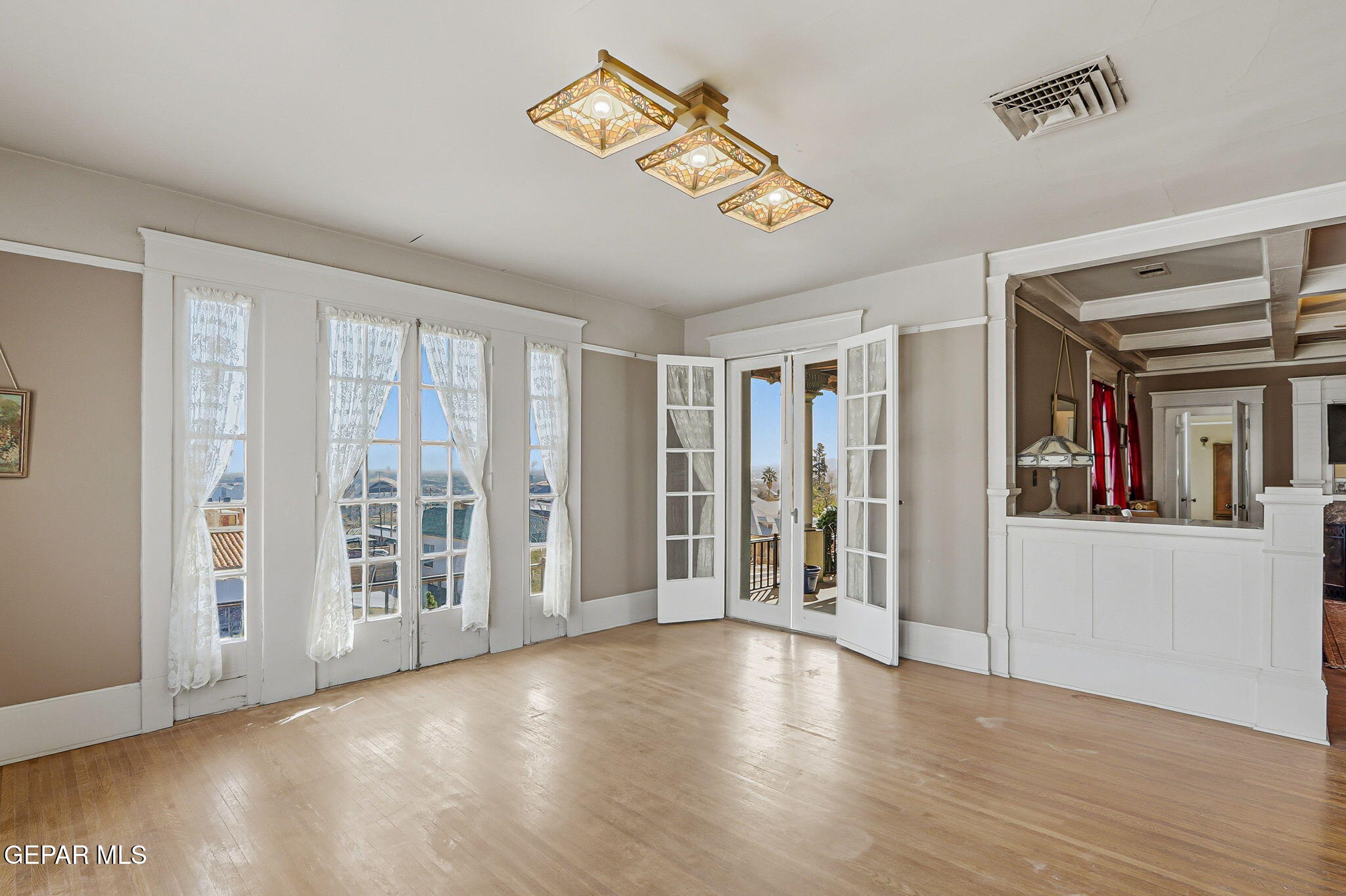 525 Corto Way El Paso, TX 79902 - Photo 34 of 98 an empty room with wooden floor and windows