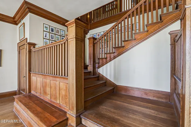 a living room with furniture a rug and a chandelier