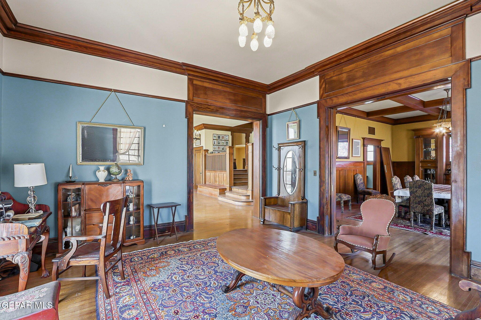 525 Corto Way El Paso, TX 79902 - Photo 80 of 98 a living room with furniture a rug and a chandelier
