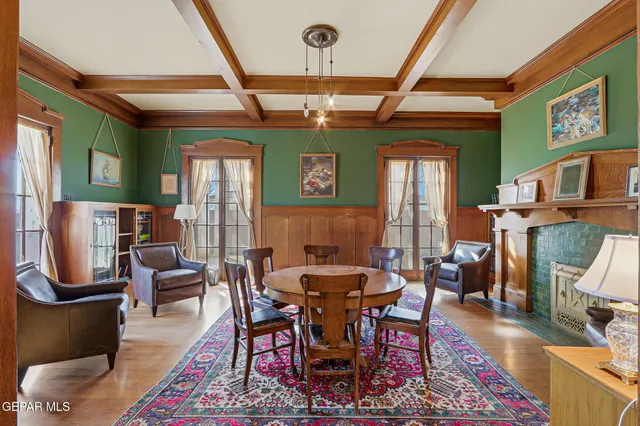 a dining room with furniture a rug and wooden floor