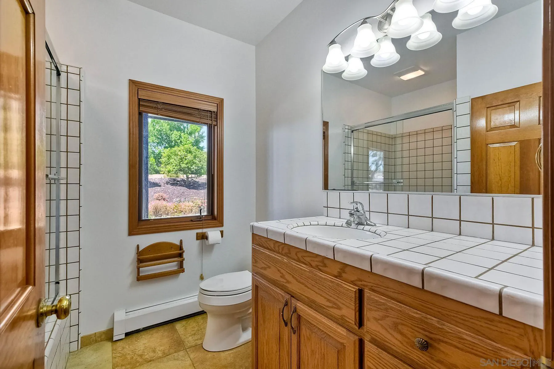 2511 Vía Rancheros Fallbrook, CA 92028 - Photo 28 of 59 a bathroom with a sink a toilet and a mirror
