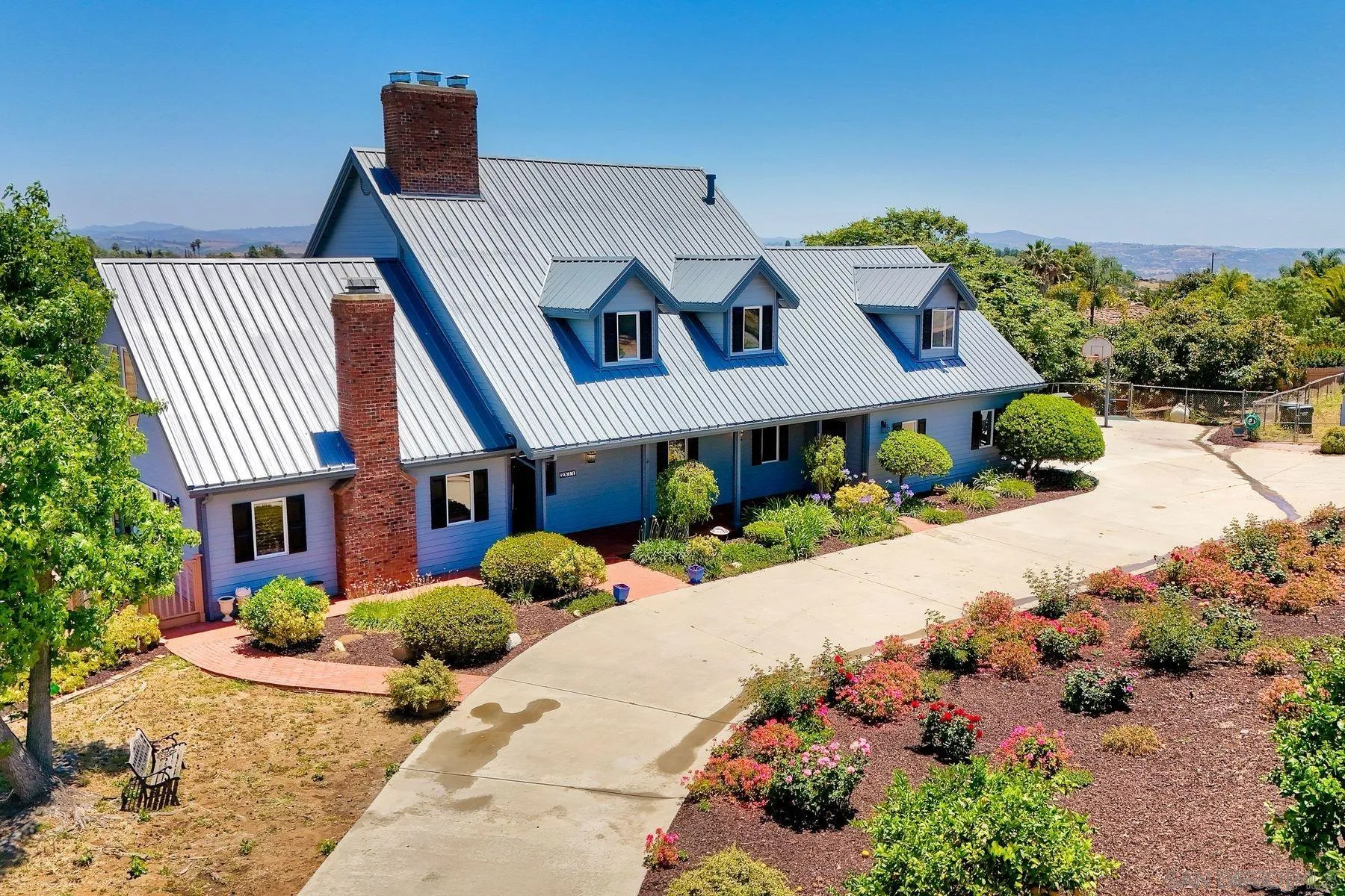 2511 Vía Rancheros Fallbrook, CA 92028 - Photo 3 of 59 a front view of a house with a yard