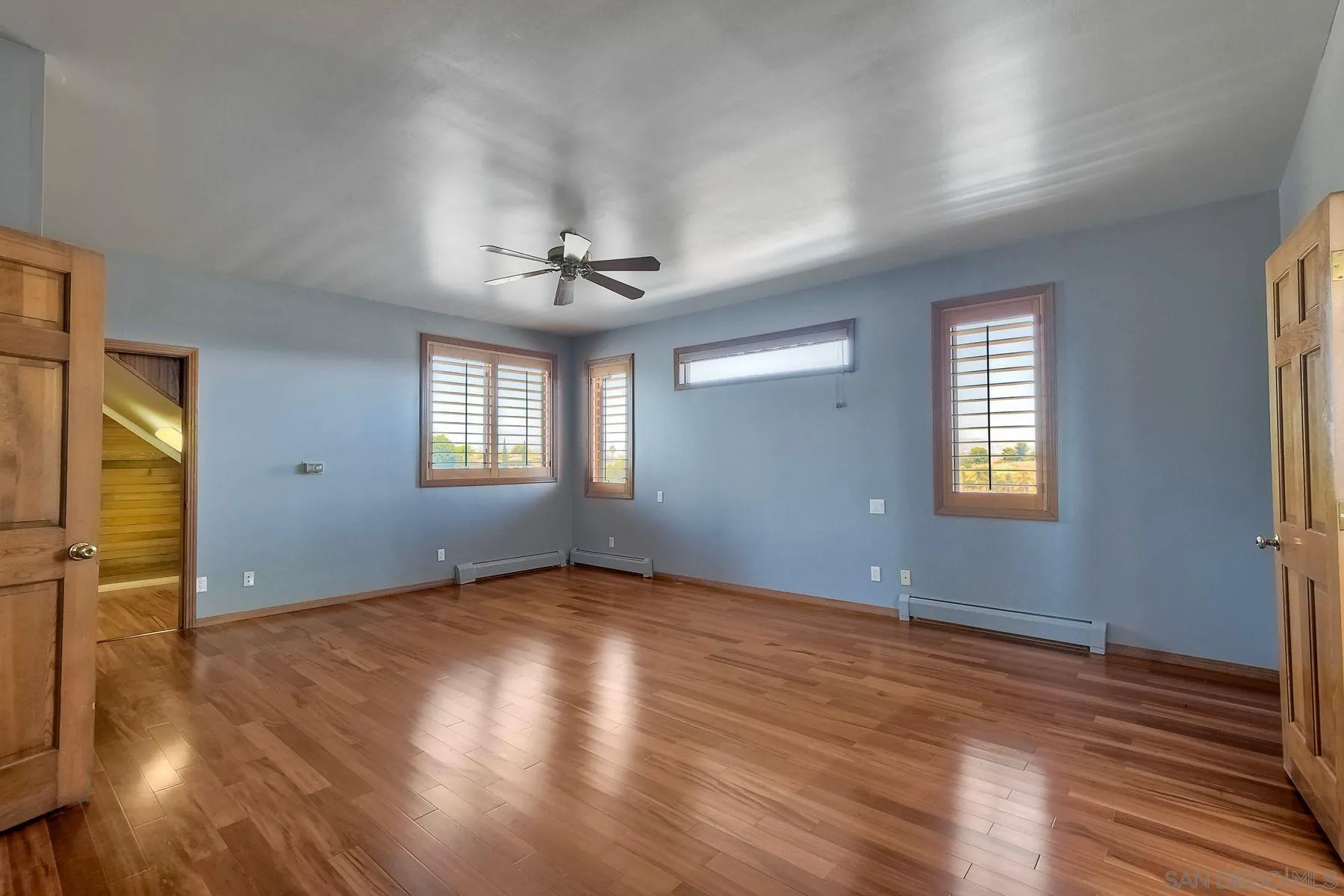 2511 Vía Rancheros Fallbrook, CA 92028 - Photo 32 of 59 an empty room with wooden floor and windows