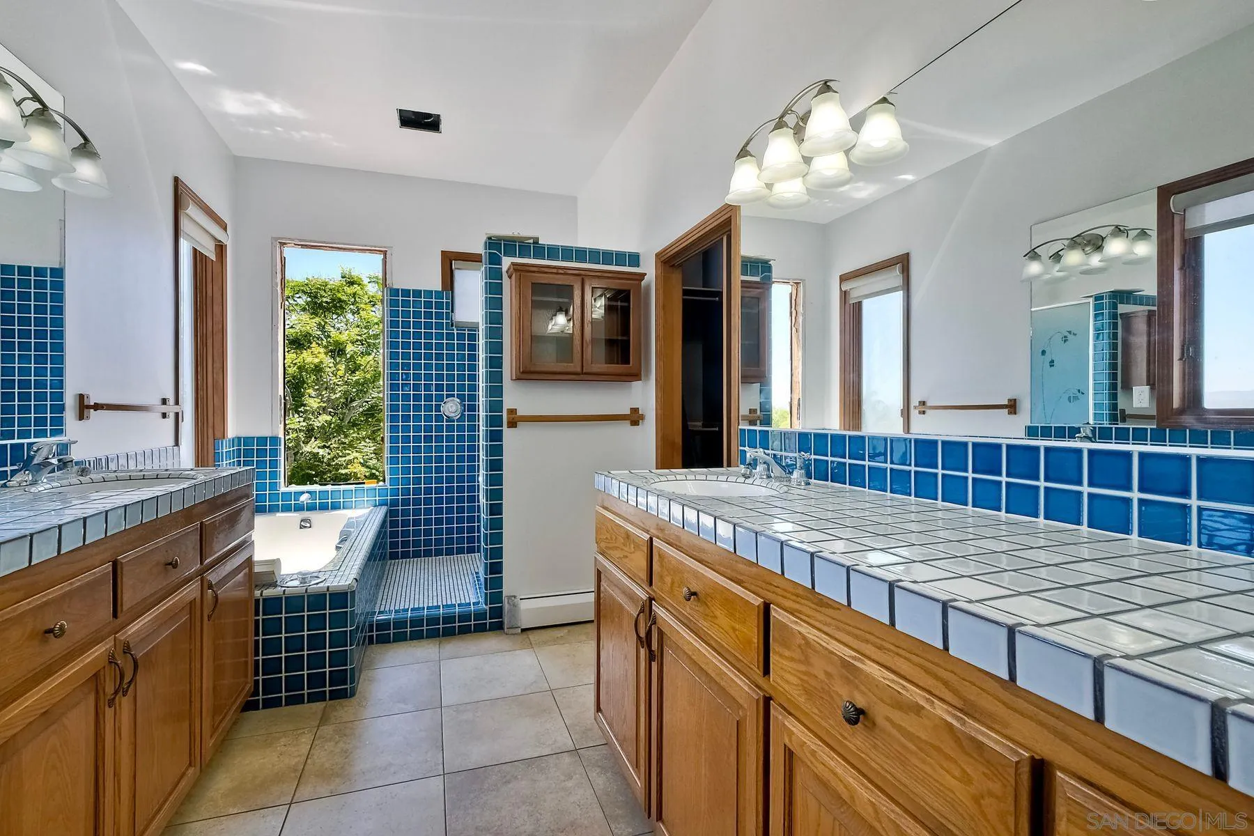 2511 Vía Rancheros Fallbrook, CA 92028 - Photo 34 of 59 a bathroom with a granite countertop sink a toilet a mirror and window