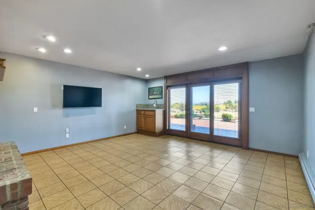 a view of balcony with wooden floor and seating space