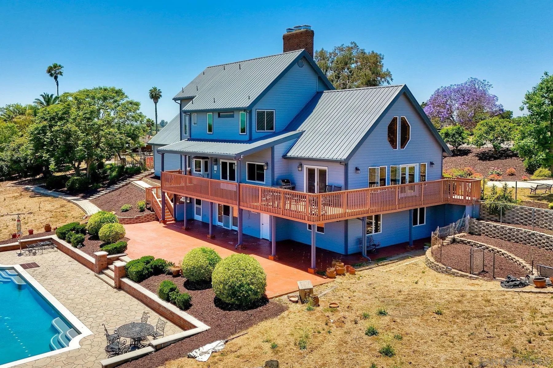 2511 Vía Rancheros Fallbrook, CA 92028 - Photo 5 of 59 a view of a house with a swimming pool