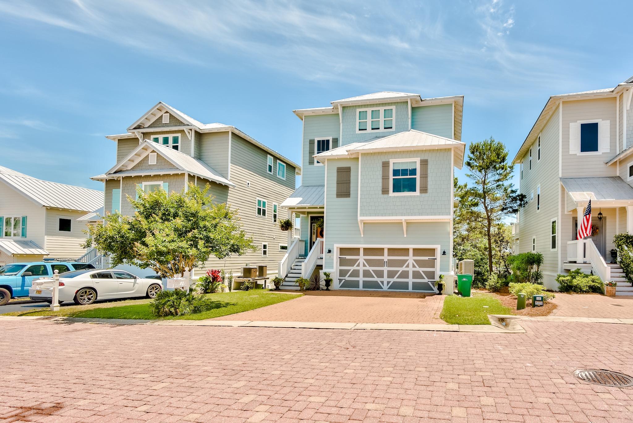 5 Inlet Cove Inlet Beach, FL 32461 - Photo 2 of 52 a front view of a house with a garden and plants
