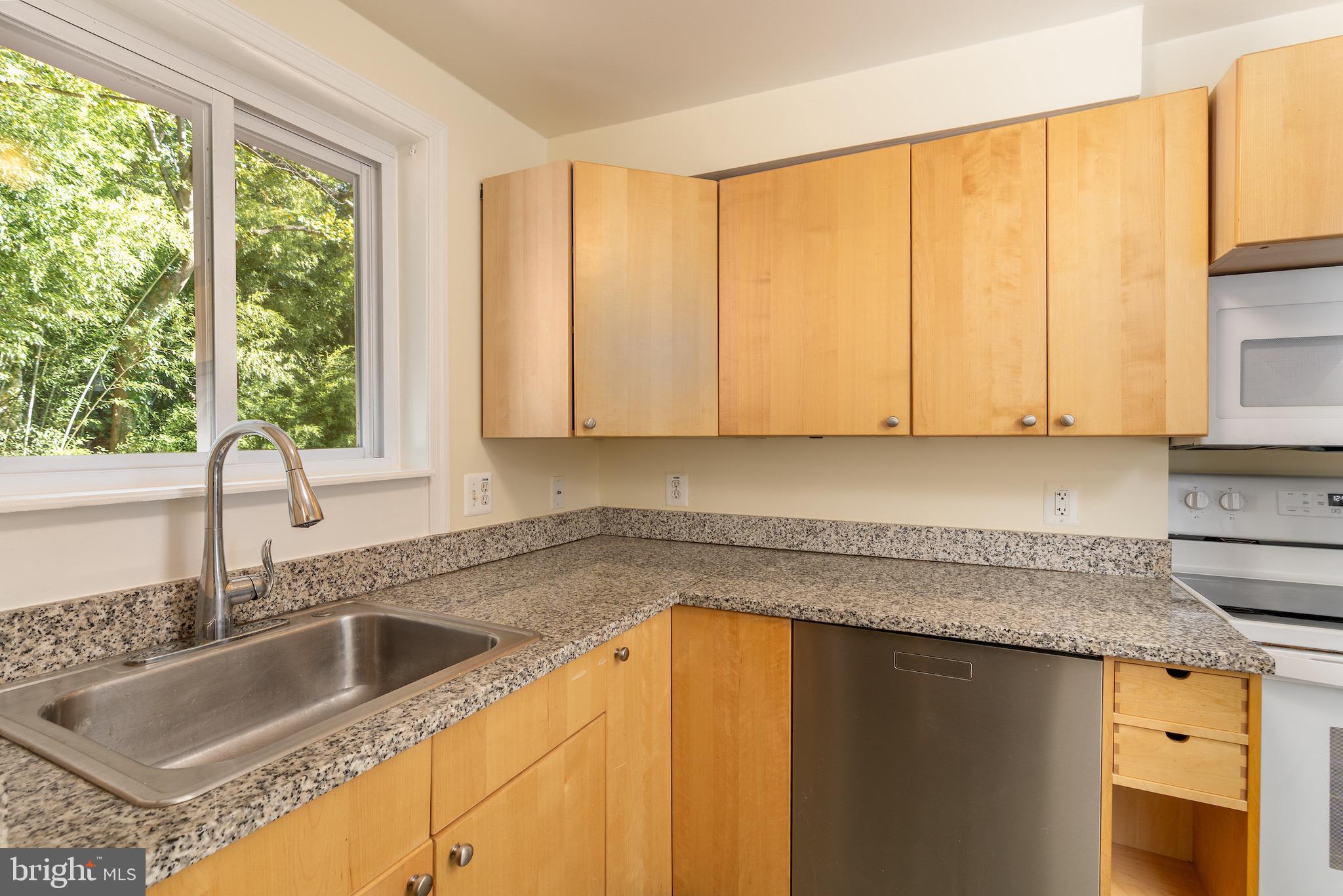 6221 Walhonding Road Bethesda, MD 20816 - Photo 13 of 51 a kitchen with granite countertop a sink a counter top space and cabinets