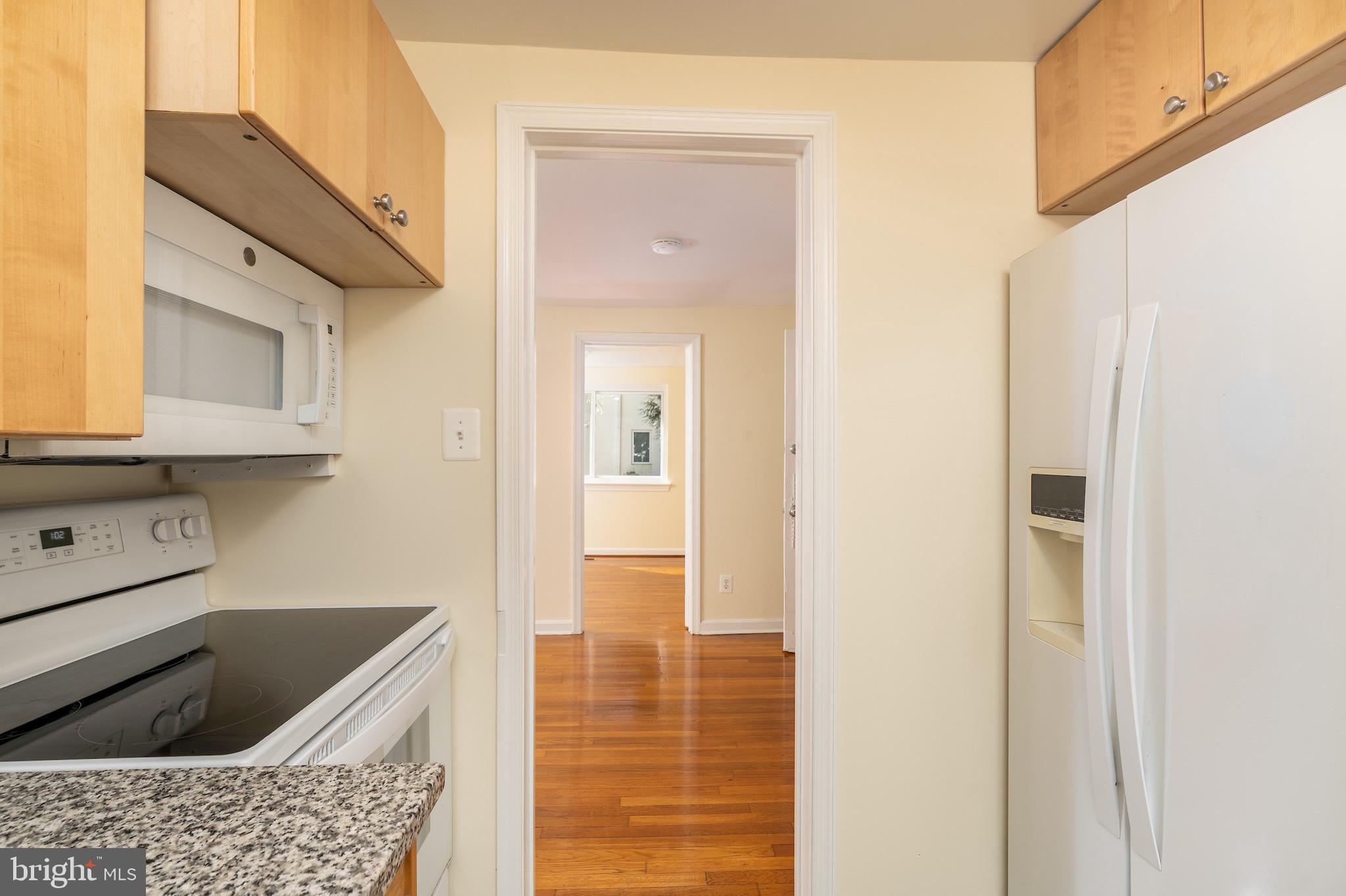 6221 Walhonding Road Bethesda, MD 20816 - Photo 15 of 51 a kitchen with granite countertop a sink and cabinets