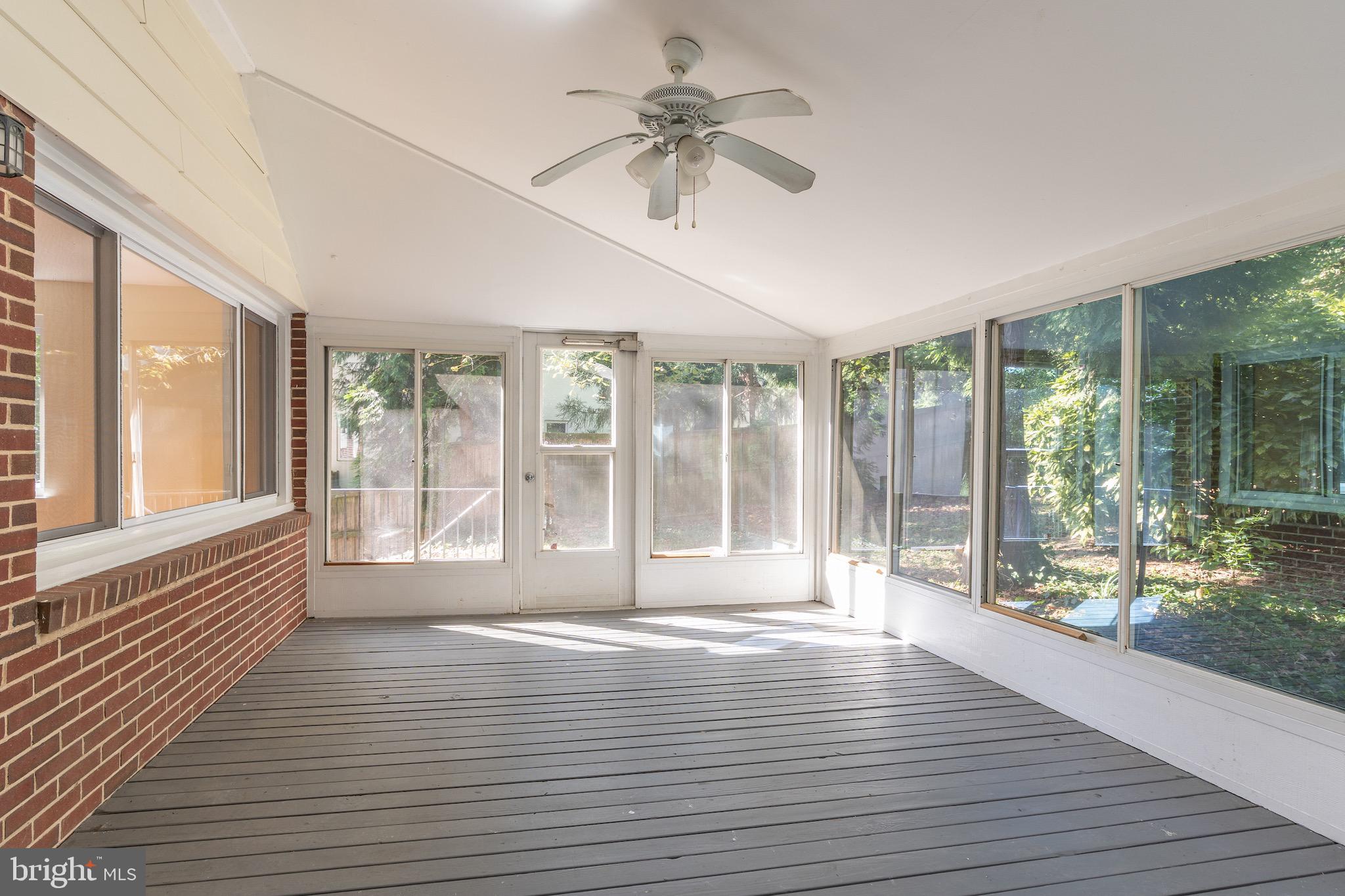 6221 Walhonding Road Bethesda, MD 20816 - Photo 23 of 51 a view of an empty room with a window and wooden floor