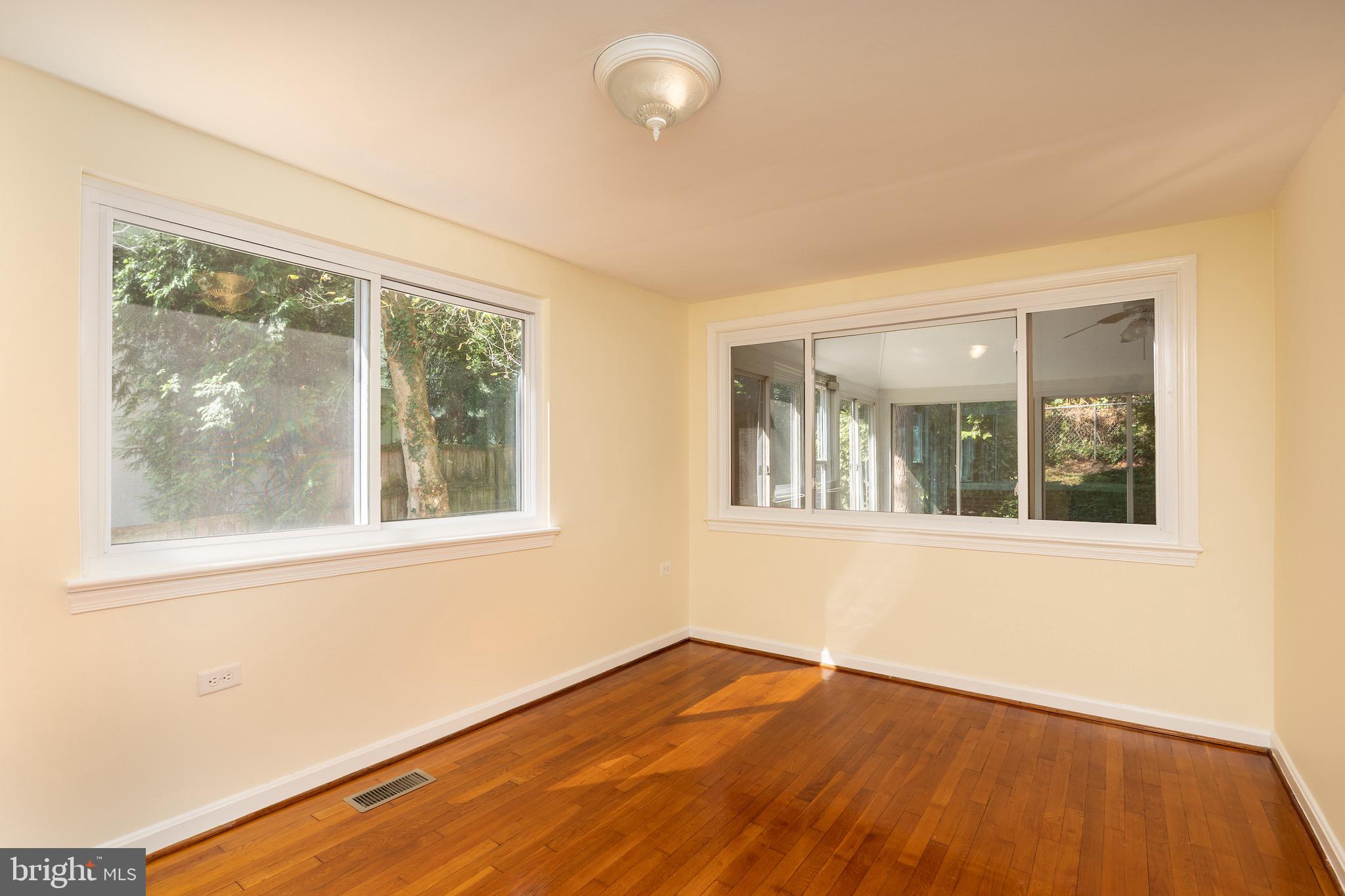 6221 Walhonding Road Bethesda, MD 20816 - Photo 29 of 51 an empty room with wooden floor and windows