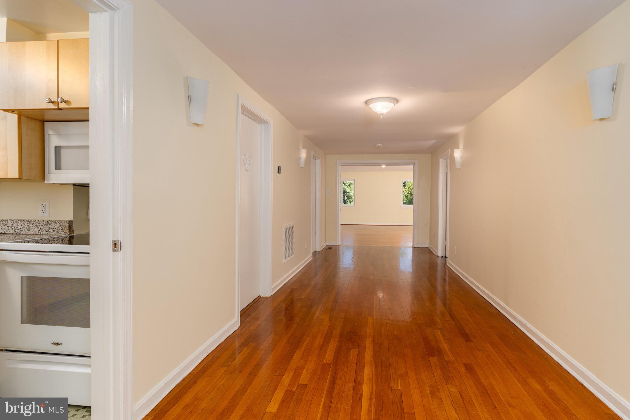 6221 Walhonding Road Bethesda, MD 20816 - Photo 3 of 51 a view of a hallway with wooden floor and staircase