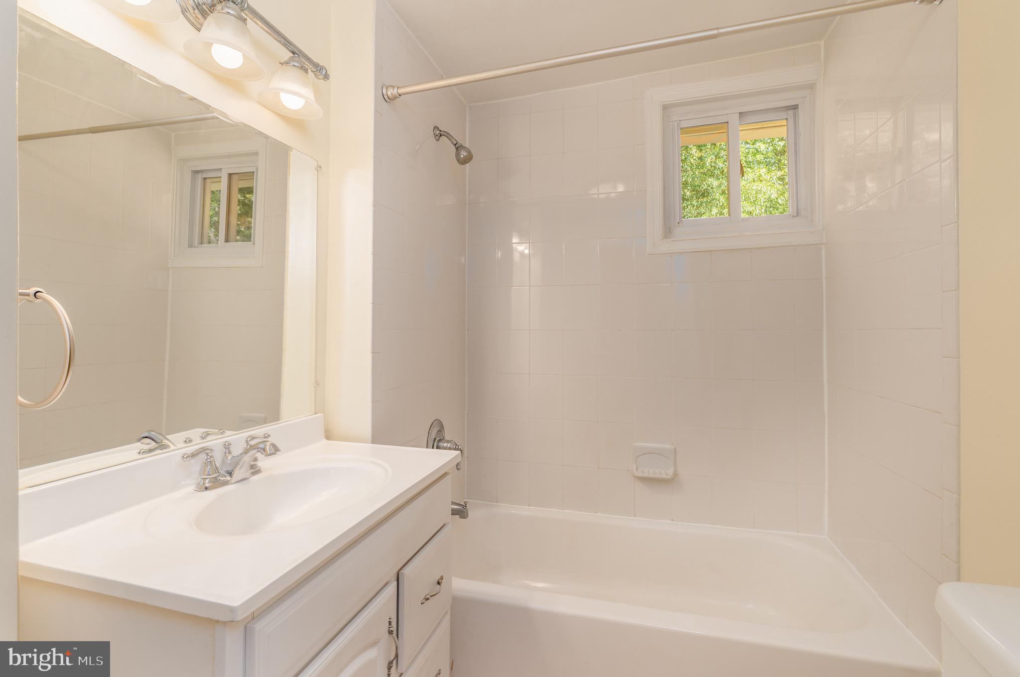6221 Walhonding Road Bethesda, MD 20816 - Photo 34 of 51 a bathroom with a sink and a bathtub