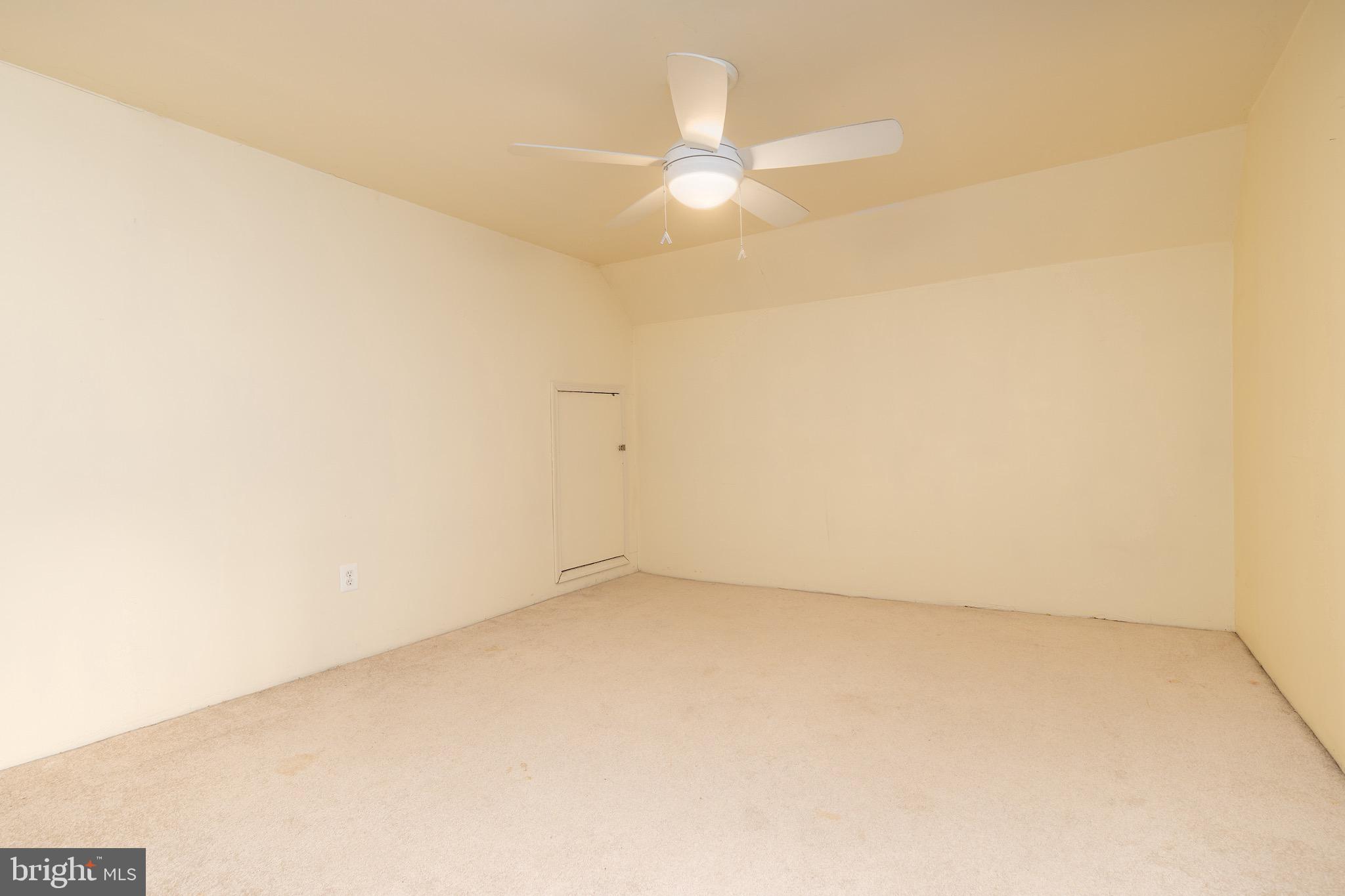 6221 Walhonding Road Bethesda, MD 20816 - Photo 42 of 51 an empty room with a ceiling fan and a window