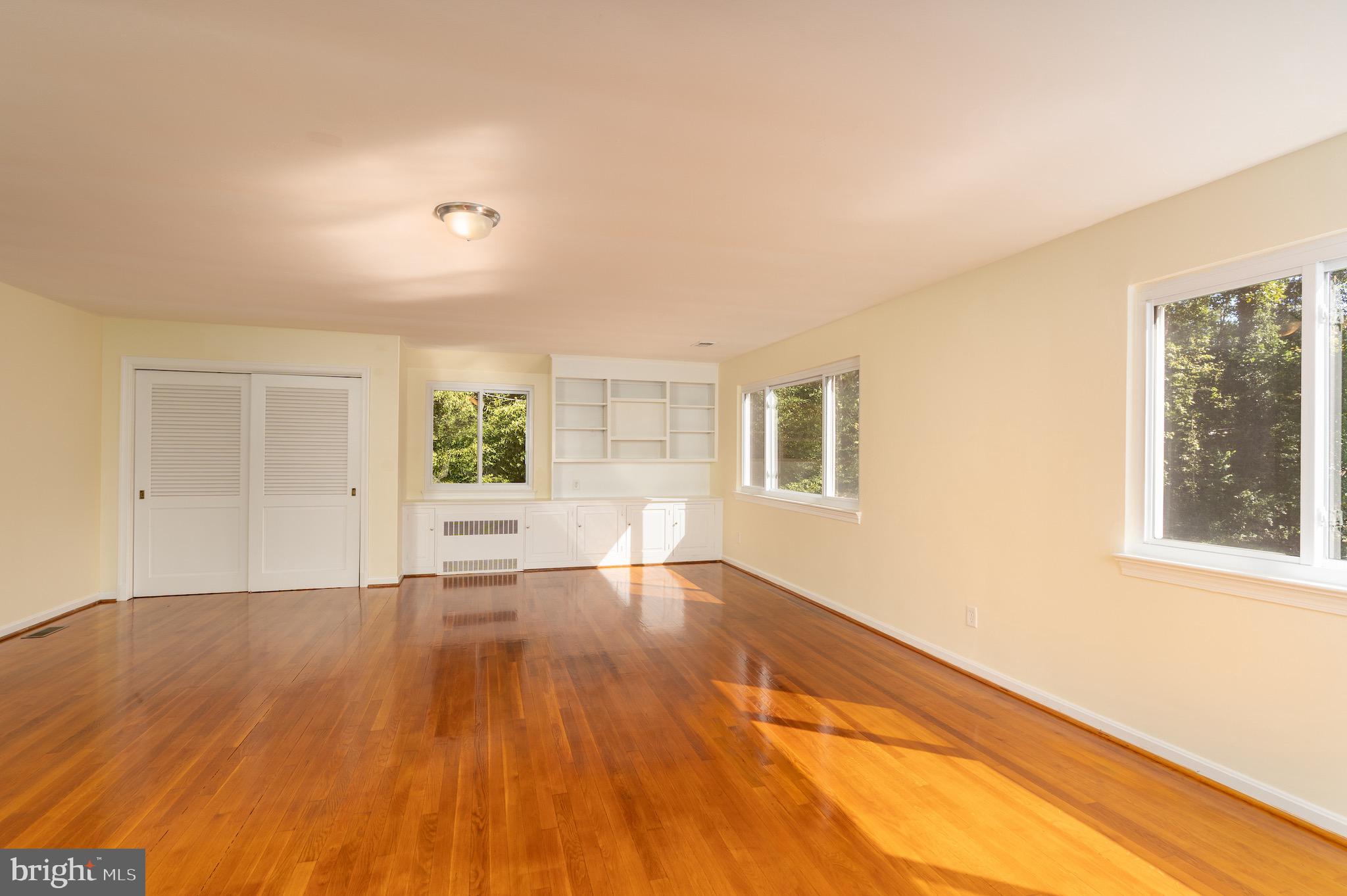 6221 Walhonding Road Bethesda, MD 20816 - Photo 8 of 51 a view of an empty room with wooden floor and a window