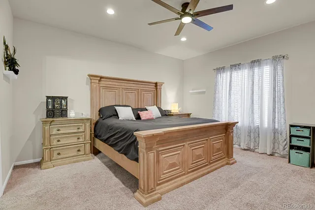 a spacious bedroom with a bed and a chandelier