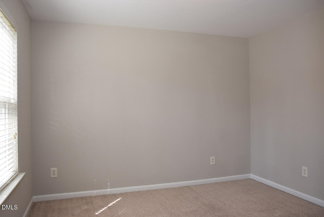 8269 City Loft Court Raleigh, NC 27613 - Photo 20 of 26 an empty room with a window