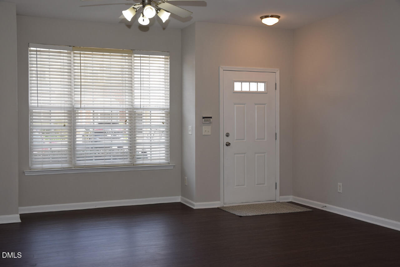 8269 City Loft Court Raleigh, NC 27613 - Photo 2 of 26 an empty room with wooden floor and windows
