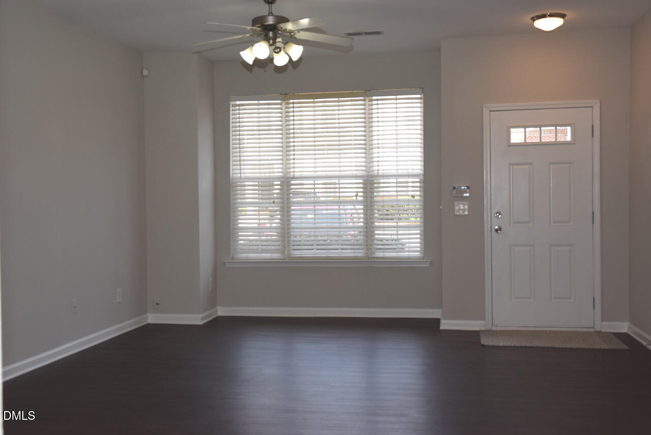 8269 City Loft Court Raleigh, NC 27613 - Photo 3 of 26 an empty room with wooden floor and windows