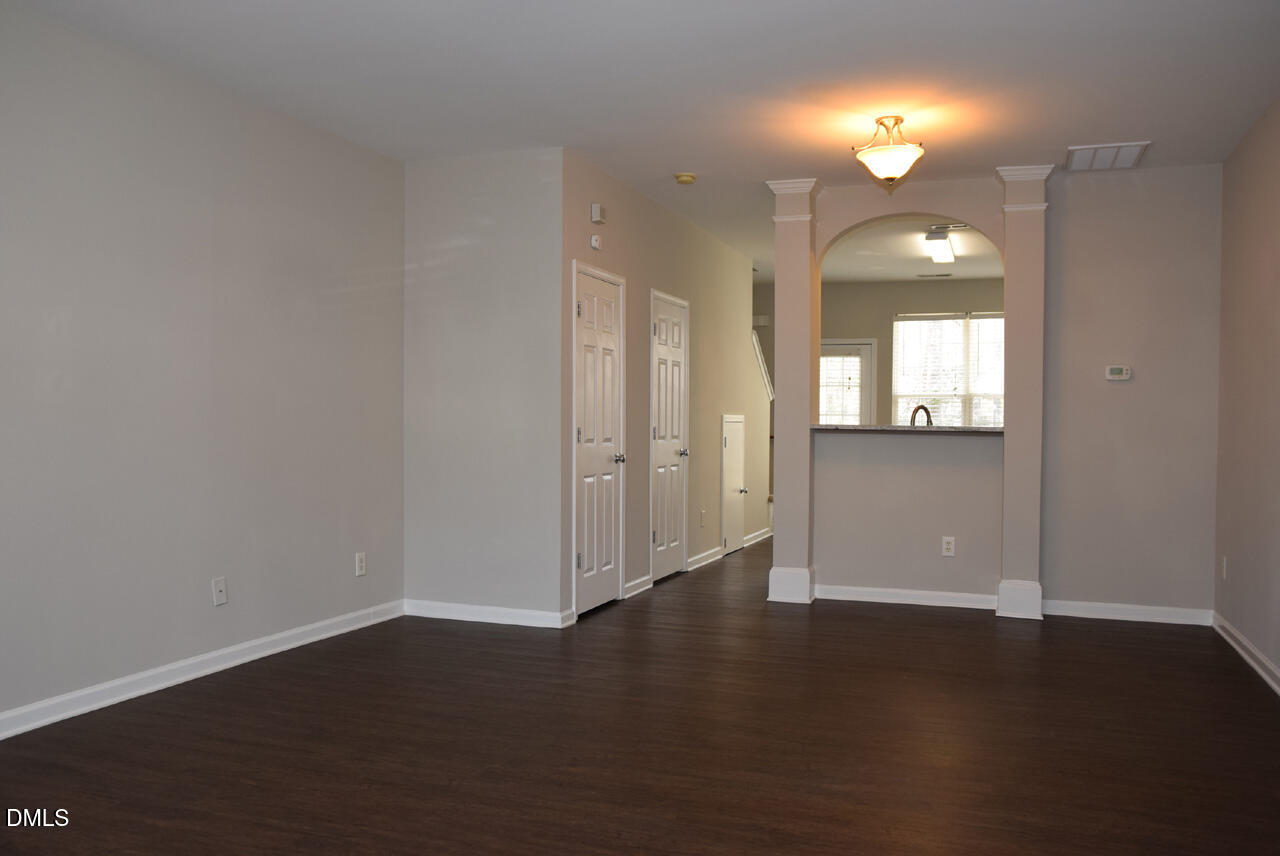 8269 City Loft Court Raleigh, NC 27613 - Photo 4 of 26 an empty room with wooden floor and windows