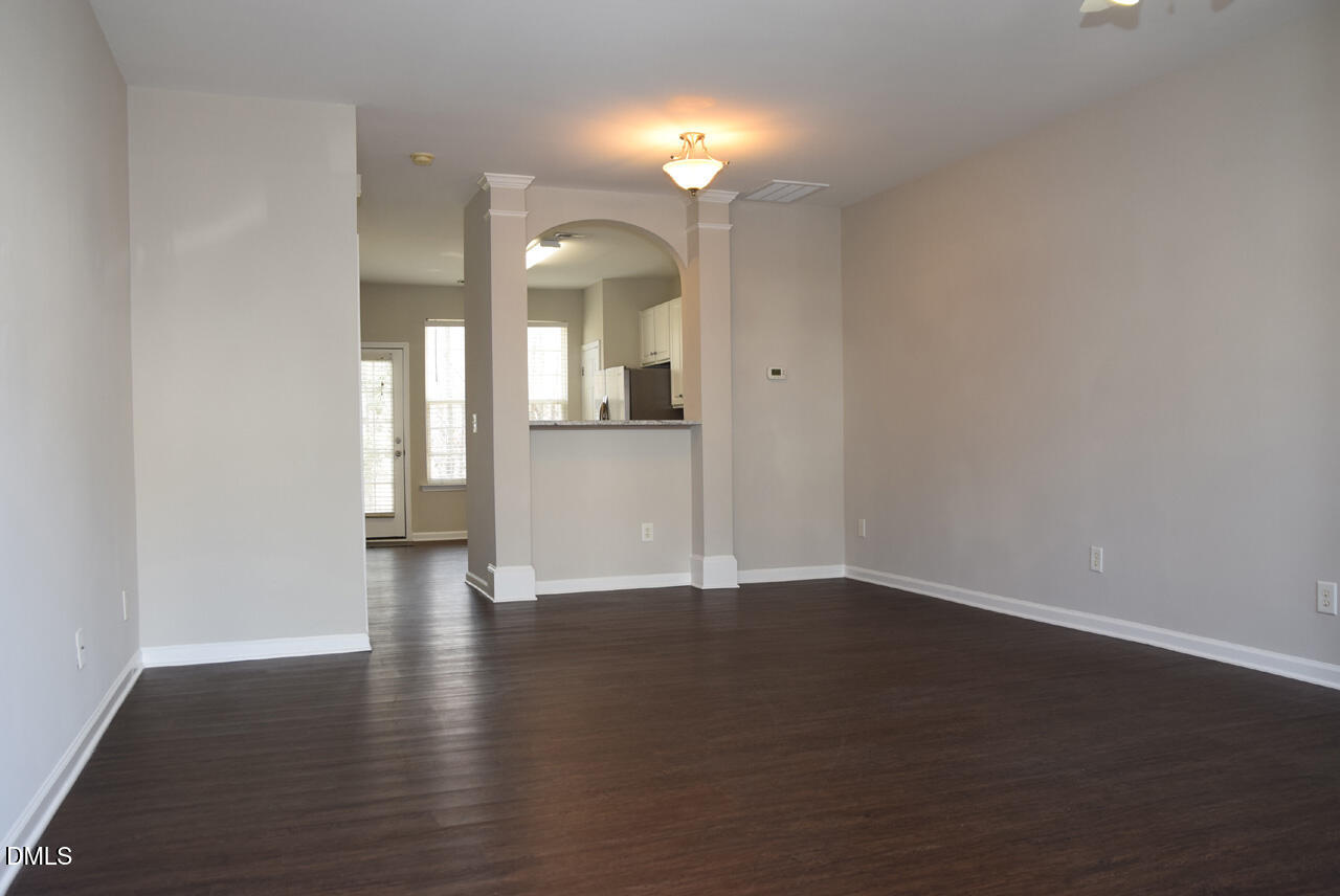 8269 City Loft Court Raleigh, NC 27613 - Photo 5 of 26 a view of a room with wooden floor and a window
