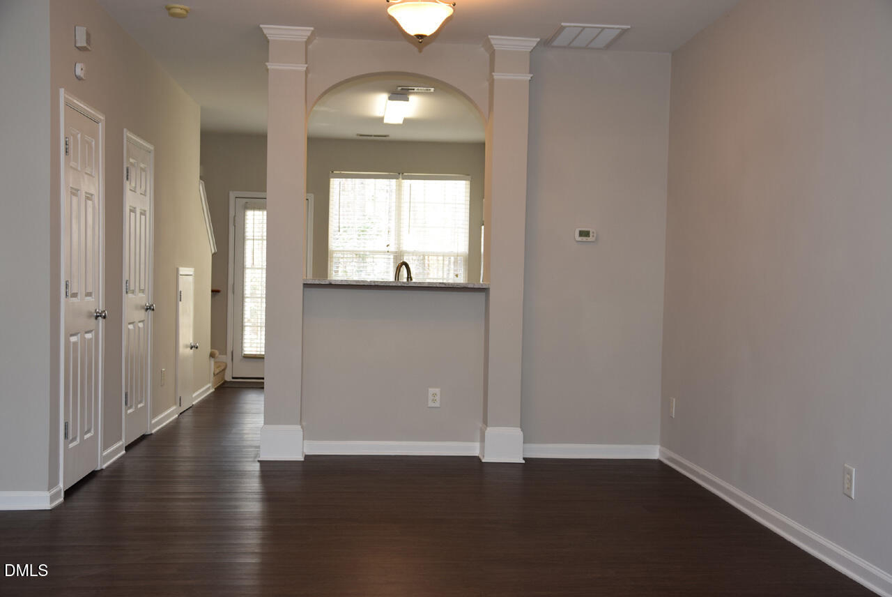 8269 City Loft Court Raleigh, NC 27613 - Photo 6 of 26 an empty room with wooden floor and windows