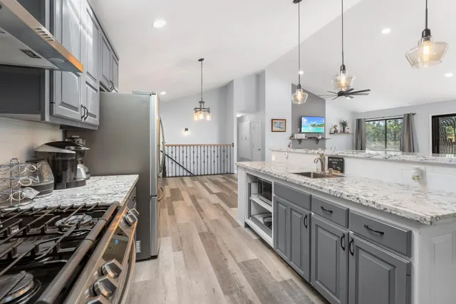a kitchen with a stove and a wooden floors