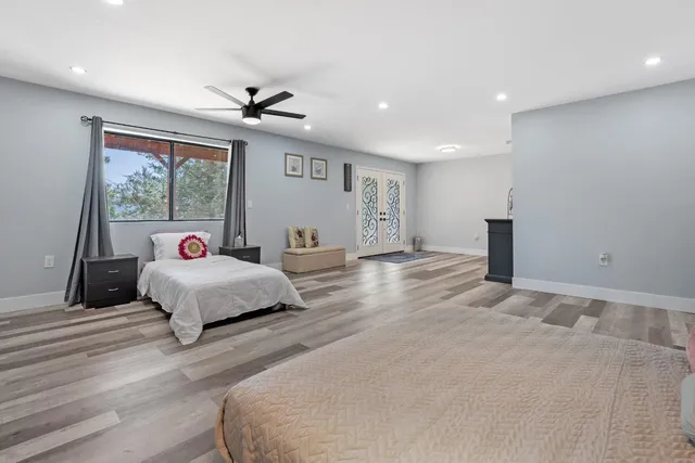 a bed room with a bed and a large window